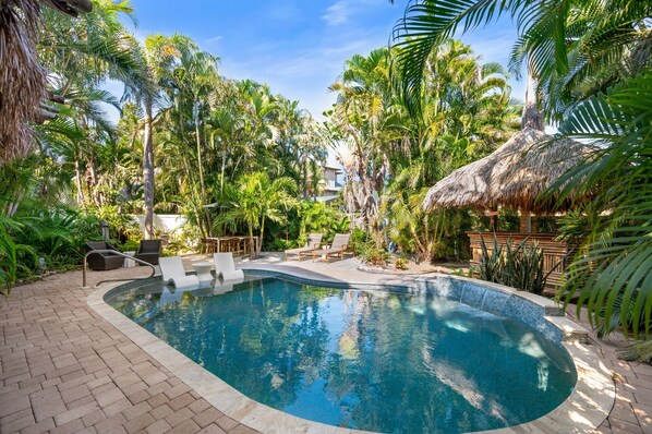 A heated pool, sun loungers