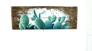 A sofa with six cushions in various colors and a rustic wall art piece above it. - Villa "La Quagliara" sea View (Ponza)