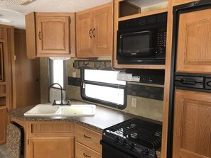 Fridge, microwave, stovetop, coffee/tea maker