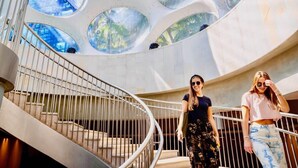 A modern building with a spiral staircase and large circular windows. - Modern Rustic 1Bdrm Condo W/Bay & Pool Views (Miami)