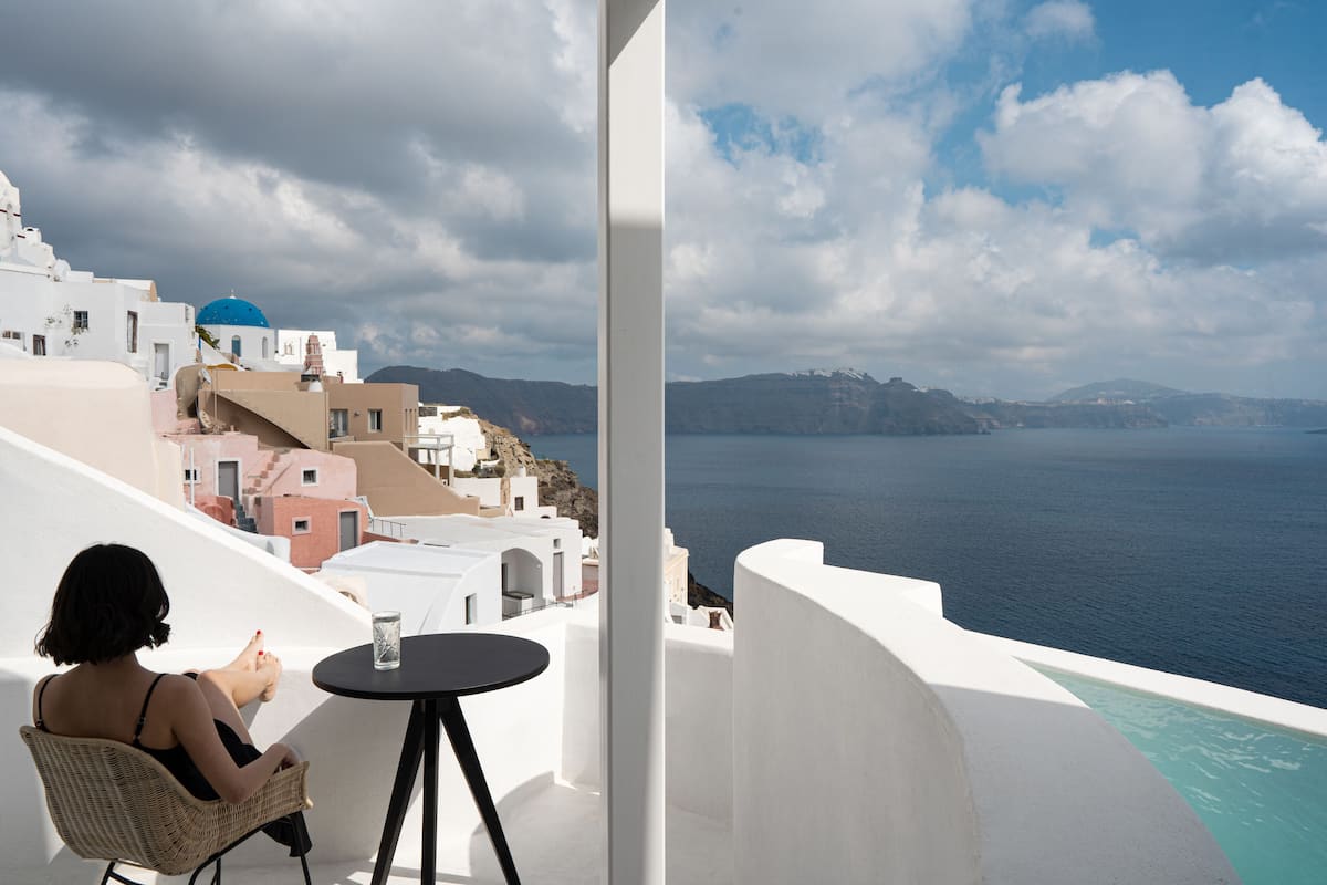 A balcony with a view of the sea and white buildings.