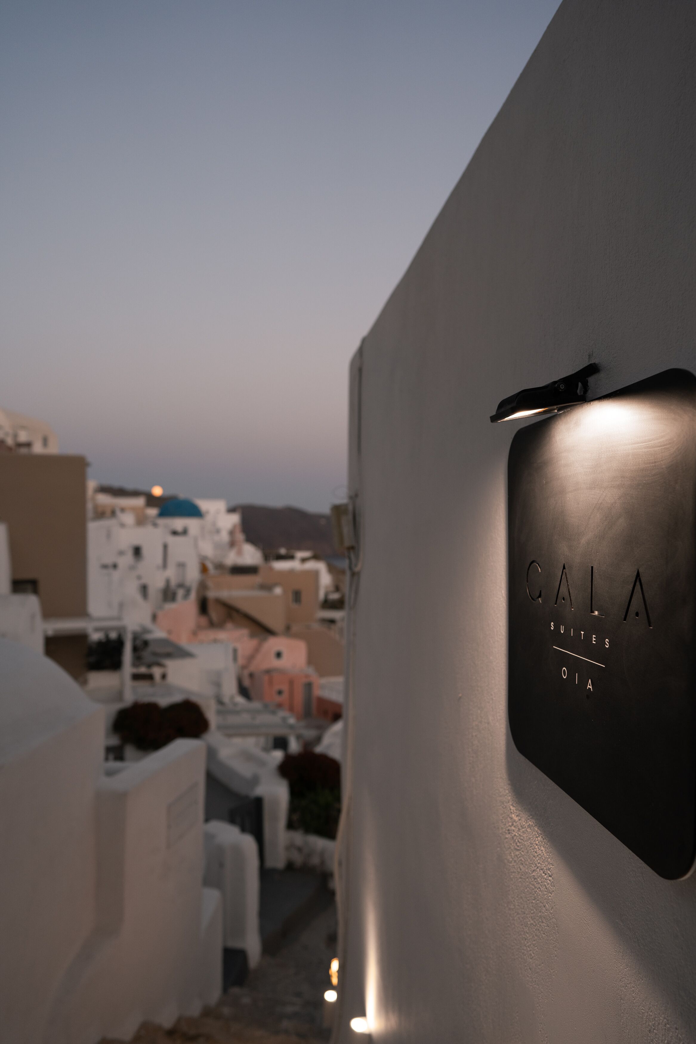 A modern building with a sign reading "CALA SUITES OIA".