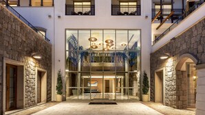 A hotel with a modern facade, multiple balconies, and a glass entrance. - Radisson Collection Hotel Bodrum (Bodrum)