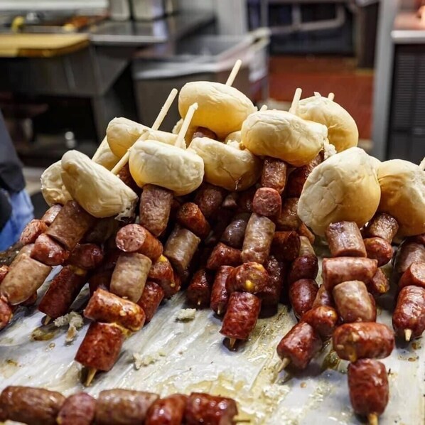 A display of skewered sausages and breadsticks.