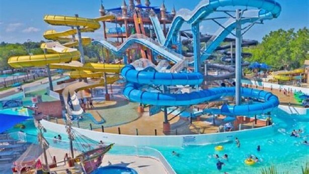 A water park with multiple water slides and pools.