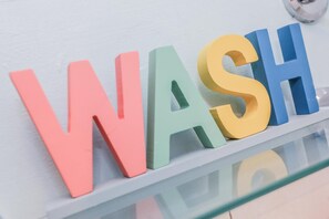 Un mur orné de lettres colorées qui épellent le mot « WASH » dans un local de stockage.