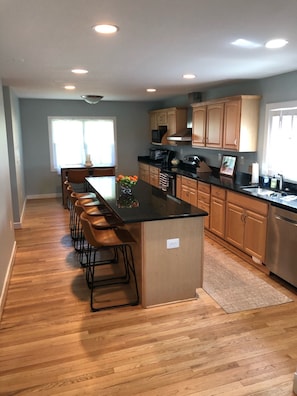 Enjoy cooking in this well-equipped kitchen with a central island and bar stools.