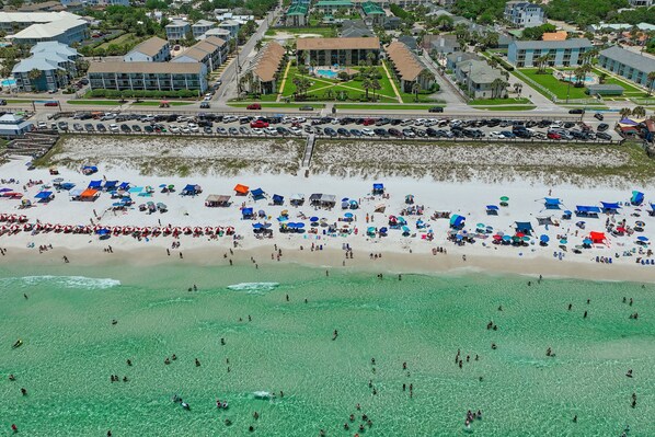 An aerial view of a beach with numerous umbrellas and people. - BOOK NOW FOR SUMMER SPECIALS - BEACH SERVICE INCLUDED - GREAT UNIT FOR COUPLES (Miramar Beach)