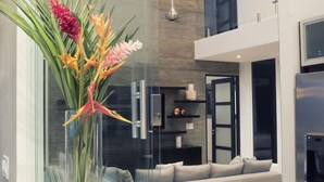 A modern kitchen with a glass vase containing flowers on the counter.