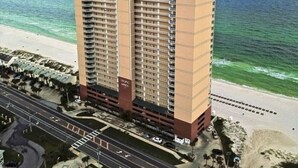 A high-rise hotel with multiple floors, a beach view, and a parking area. - Penthouse! Great Rates! Quiet, Clean, Well Maintained Building. Book Now. (Panama City Beach)