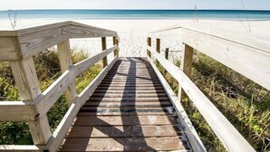 A wooden boardwalk leading to a beach with clear skies. - Penthouse! Great Rates! Quiet, Clean, Well Maintained Building. Book Now. (Panama City Beach)