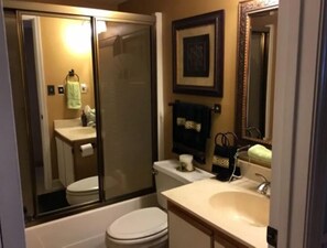 A bathroom with a toilet, sink, and shower area. - Ground floor Condo - No need for elevators - Steps away to the beach and pool. (Murrells Inlet)