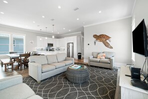 A modern living room with a sofa, coffee table, and a television.