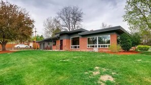 A modern two-story house with a brick exterior, large windows, and a well-maintained lawn. - Mid-Century 3 Bdr Lakewood Home Mountain Access! (Lakewood)