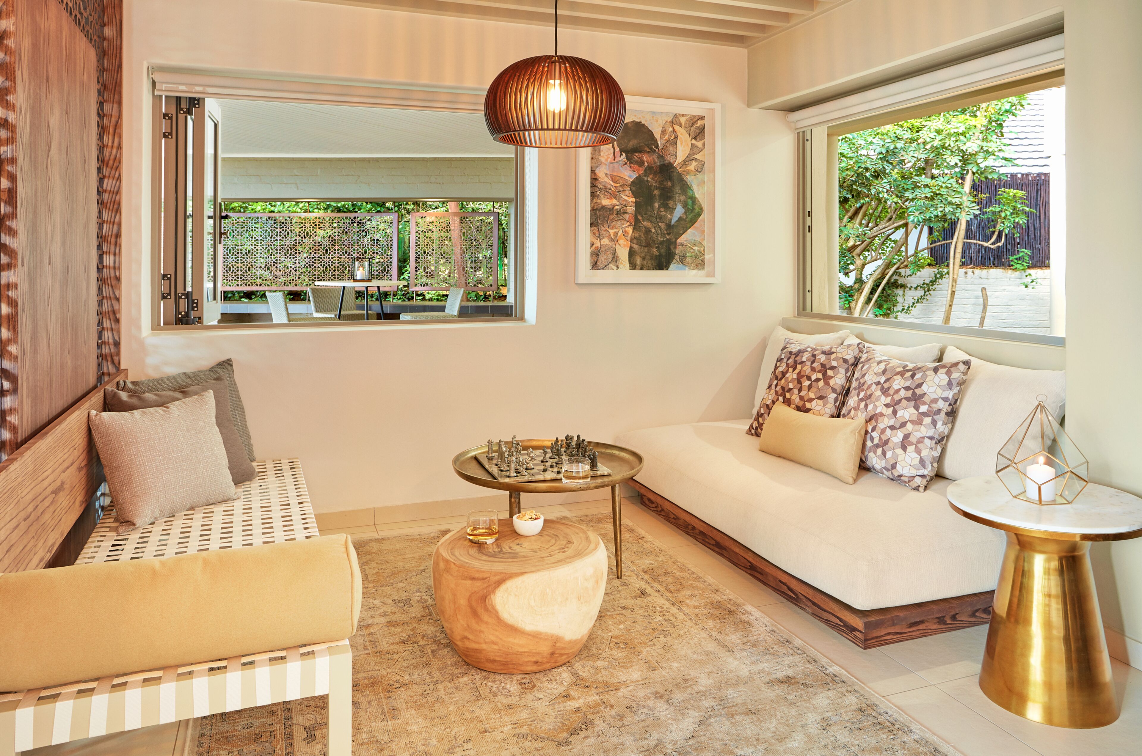 A cozy living room with a sofa, a wooden coffee table, and a side table with a candle.