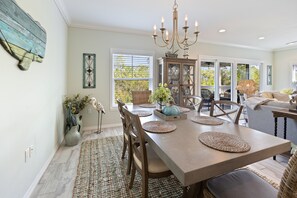 Enjoy meals with family and friends at this cozy dining area, featuring a large table and comfortable seating for four.