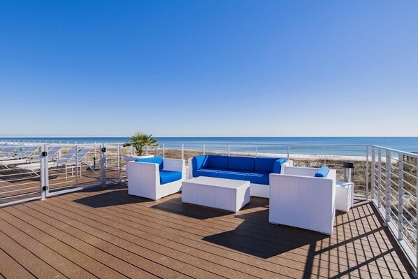 Relax on the ocean-view deck with a sofa, armchairs, and sun loungers.