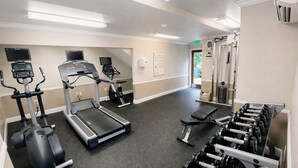 A gym with treadmills, elliptical machines, a bench press, and dumbbells. - Down Town Convenience, TRAX, Self Check-In Studio (Salt Lake City)