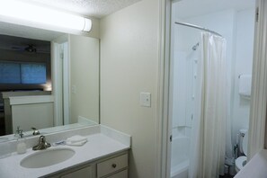 A bathroom with a sink, mirror, and shower curtain. - Two Bedroom Loft, King Beds, Down Town Convenience (Salt Lake City)