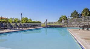 Relax by the pool with a view of the surrounding landscape.