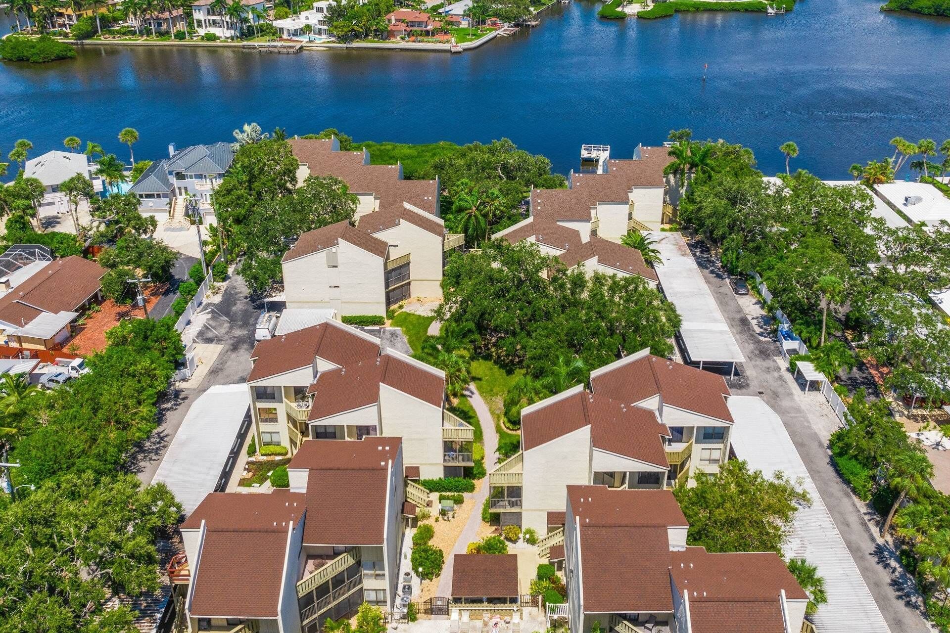 A residential area with houses, a marina, and a small island.