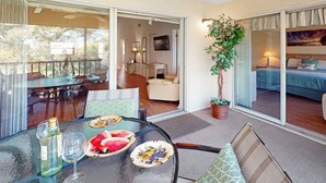 A dining area with a glass table, chairs, and a bottle of water. - Hickory on the Golf Course (Sarasota)