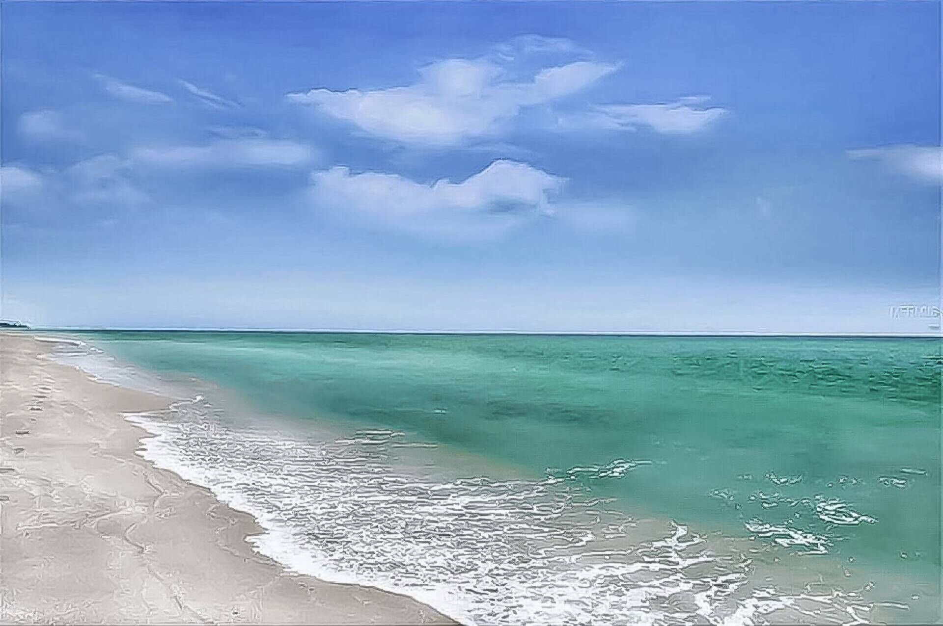 Una spiaggia con acque cristalline turchesi e una riva sabbiosa sotto un cielo azzurro con nuvole.