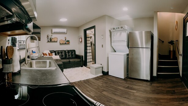 A compact kitchen with a built-in oven, a refrigerator, and a washing machine. - City Loft  (Trenton)