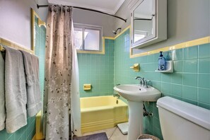 A bathroom with a bathtub, a sink, and a toilet.