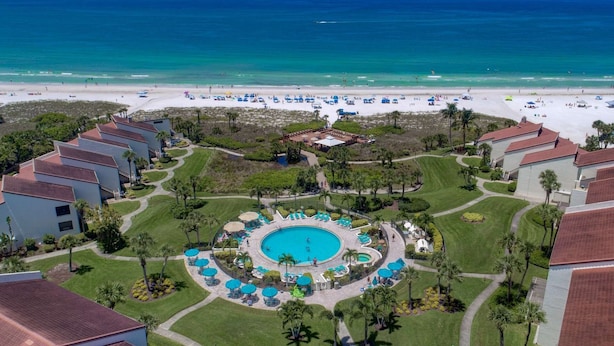 A resort with a central pool, beach access, and multiple buildings with red roofs. - Siesta Dunes on Siesta Key (Siesta Key)