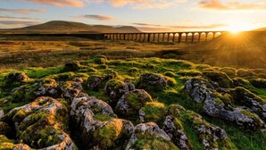 A stone bridge over a grassy field with moss-covered rocks in the foreground. - Remarkable 1-bed Apartment in Kirkby Lonsdale (Carnforth)