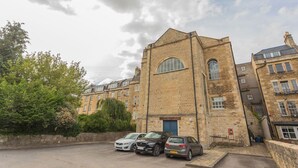 A building with a prominent arched window and a brick facade. - Kensington Chapel Apartments in Bath  (Bath)