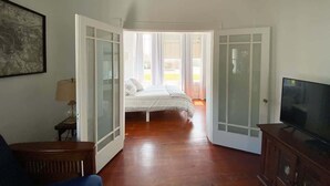 Une chambre à coucher avec un lit, une télévision et un bureau.
