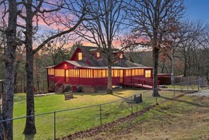 A red house with a large porch and a fenced yard. - Salt Creek Cabin at Lake Tenkiller (Park Hill)