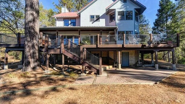 A two-story house with a covered porch and a staircase leading to the upper level. - Cozy house 1.1 miles away from Dark Day boat launch at Bullards Bar Reservoir  (Camptonville)