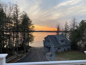 Situated lakeside, this house offers a tranquil retreat with a porch and scenic views.