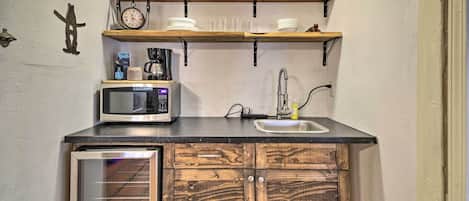 Fridge, microwave, coffee/tea maker, cookware/dishes/utensils