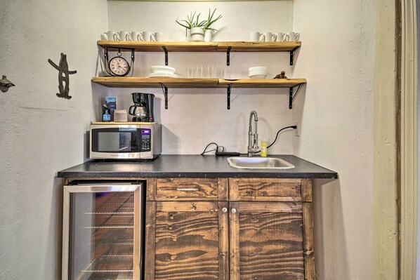 Fridge, microwave, coffee/tea maker, cookware/dishes/utensils