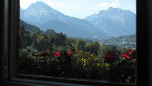 A mountain landscape with a town in the valley below.