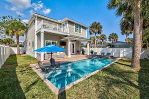 A two-story house with a swimming pool, a covered patio, and a white fence. - Heated Pool + Games | Golf Cart | Near Beach (Jacksonville Beach)