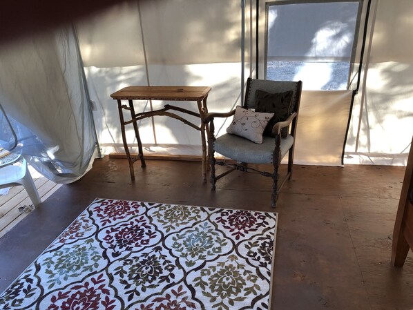 A room with a wooden chair, a small table, and a patterned rug. - Glamping #4, Nature Immersion, River access, Butterfly Pavilion (Cave Junction)