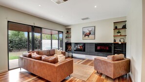 TV, fireplace - Banksia House - 5 Bedroom 2 bathroom home with pool and large yard. (Mansfield)