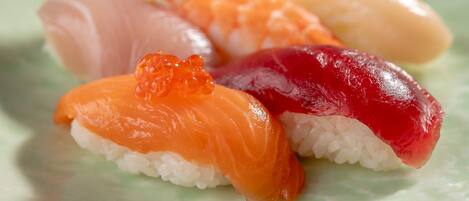 A plate of sushi with various types of fish and toppings.