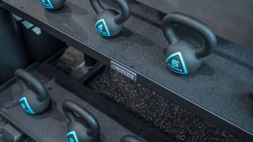 A rack of kettlebells with a label that reads "RECOR".