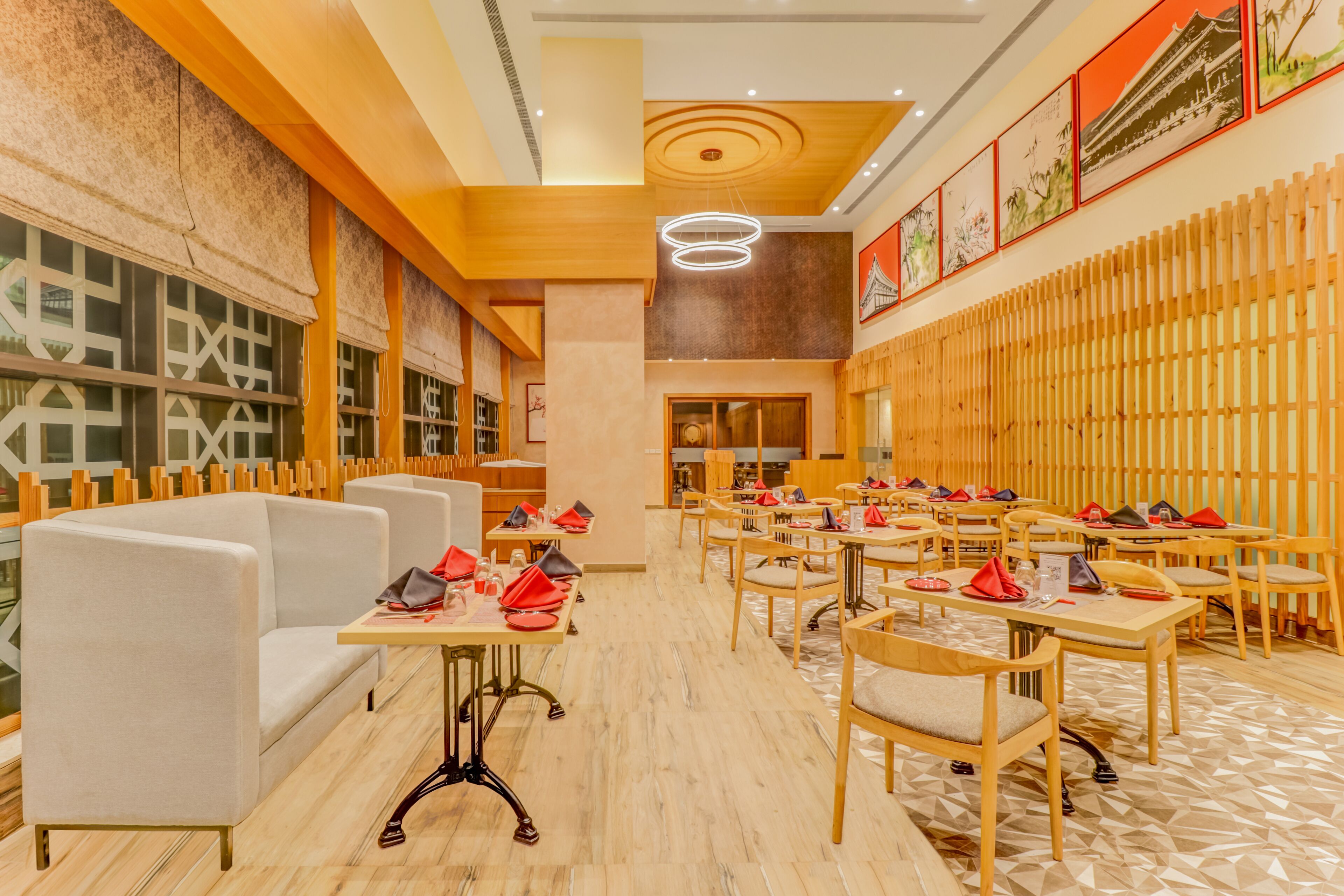 A restaurant with wooden furniture, tables, and chairs.