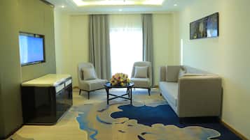 Executive Suite | Living area | 43-inch Smart TV with satellite channels, TV