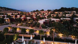 A resort with multiple villas, outdoor seating areas, and a view of the surrounding landscape. - Arameras Resort (Ksamil)