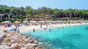 On the beach, white sand, beach umbrellas, beach bar