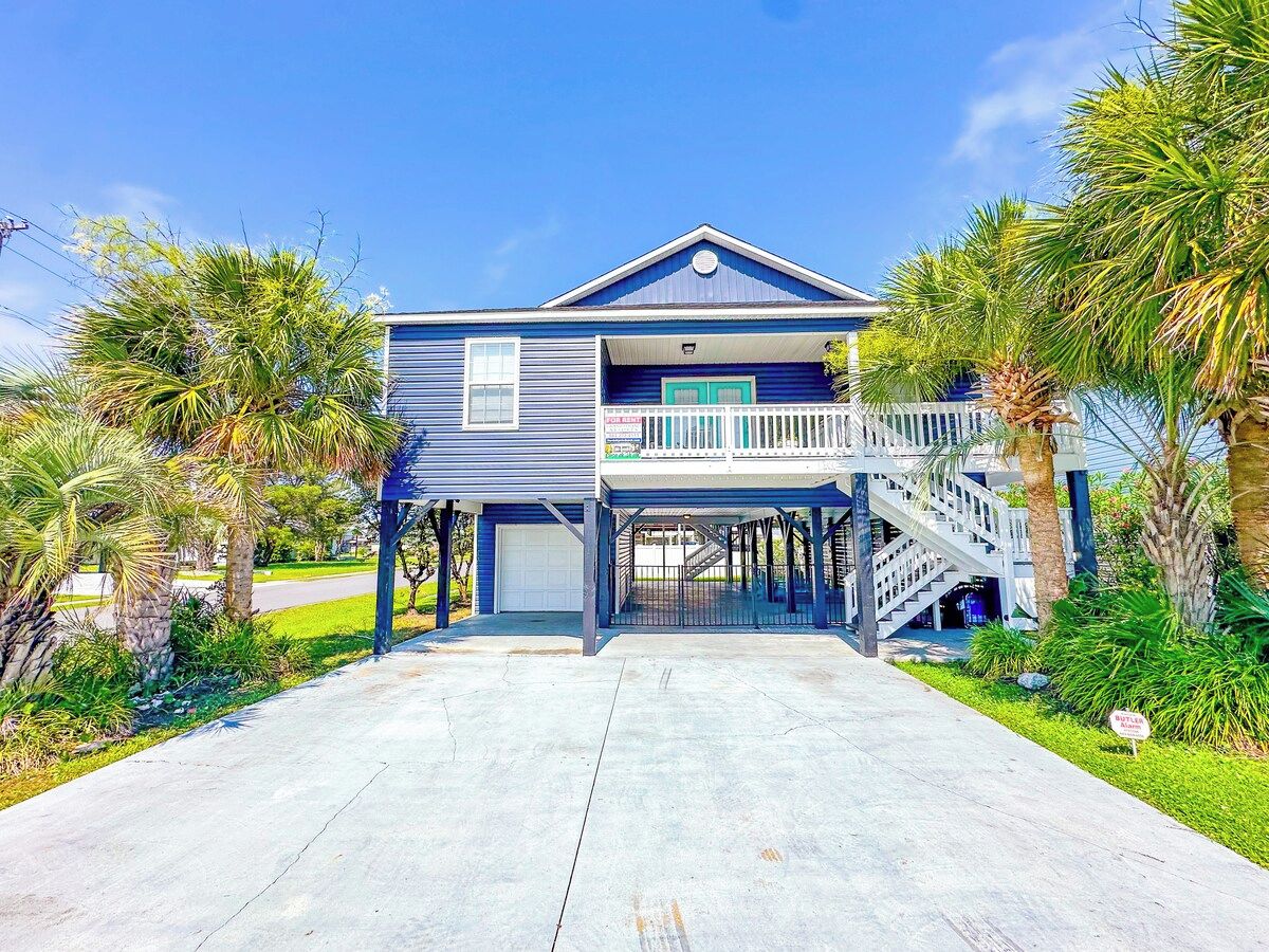 A two-story house with a balcony and a covered porch.