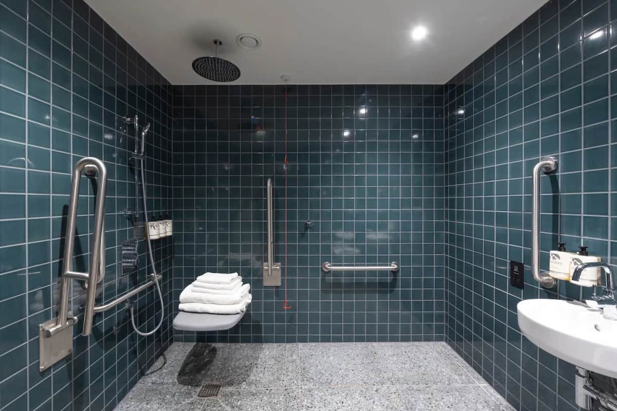 accessible room | bathroom | shower, rainfall showerhead, hair dryer, towels